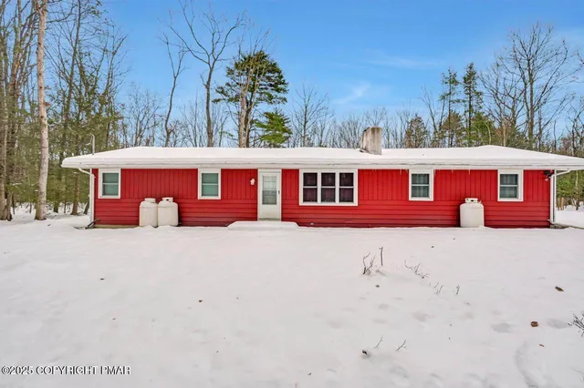 an outdoor space with swimming pool and furniture