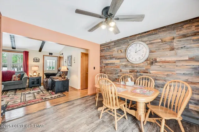 a kitchen with stainless steel appliances granite countertop a refrigerator a stove a sink and a refrigerator with wooden floor