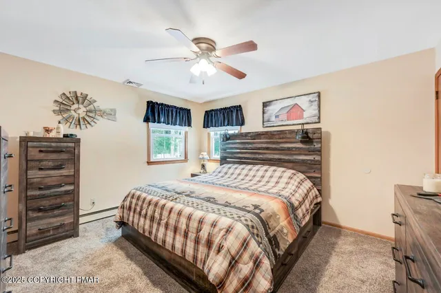 a bedroom with a bed a mirror and a window