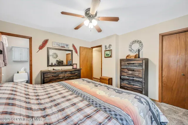 a bed room with a bed dresser and a window