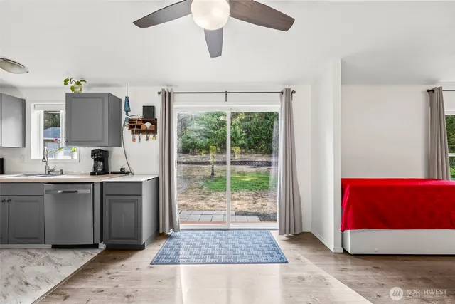 a kitchen with stainless steel appliances granite countertop a refrigerator a stove top oven a sink and dishwasher