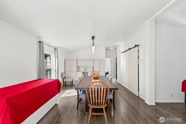 a view of a dining room with furniture and wooden floor