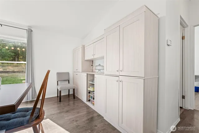 a view of kitchen with furniture and refrigerator