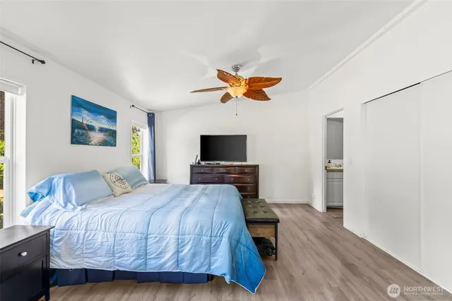 a bedroom with a bed and a flat screen tv