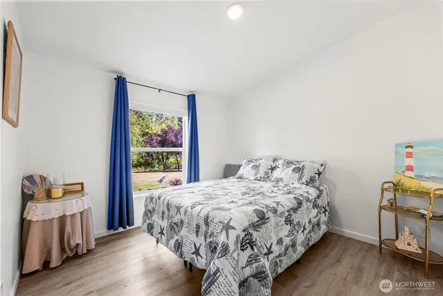a bed sitting in a bedroom next to a window
