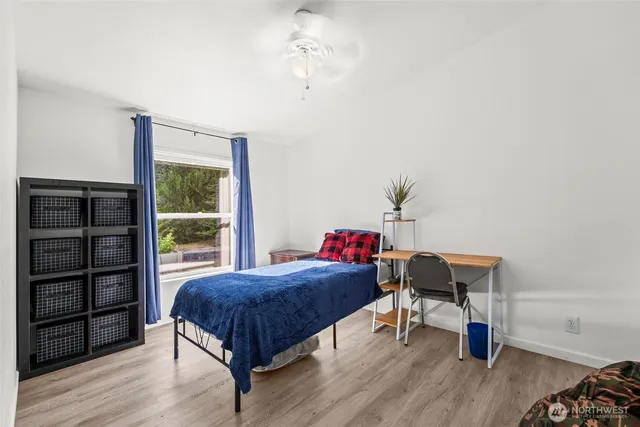 a living room with a bed furniture and a window