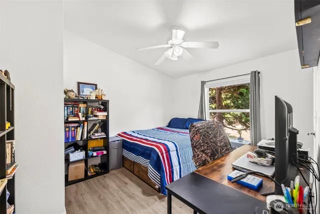 a bedroom with a bed and a bookshelf