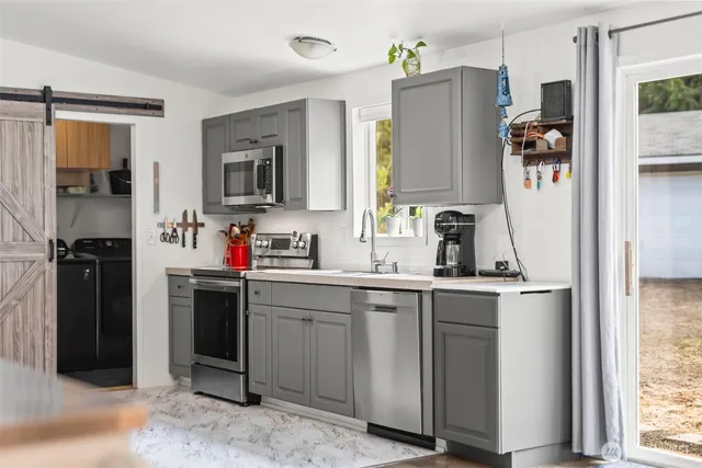a kitchen with a sink and refrigerator
