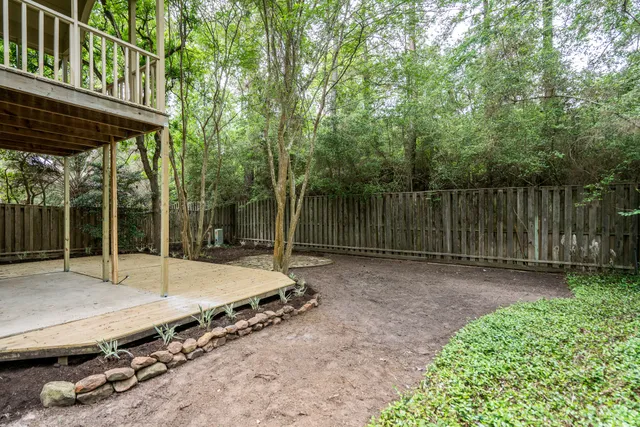 a backyard of a house with barbeque oven table and chairs