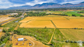 19 East Southfield Road Spanish Fork, UT 84660 - Photo 29 of 74 Aerial view of sparsely populated area with mountains and abundant farmland