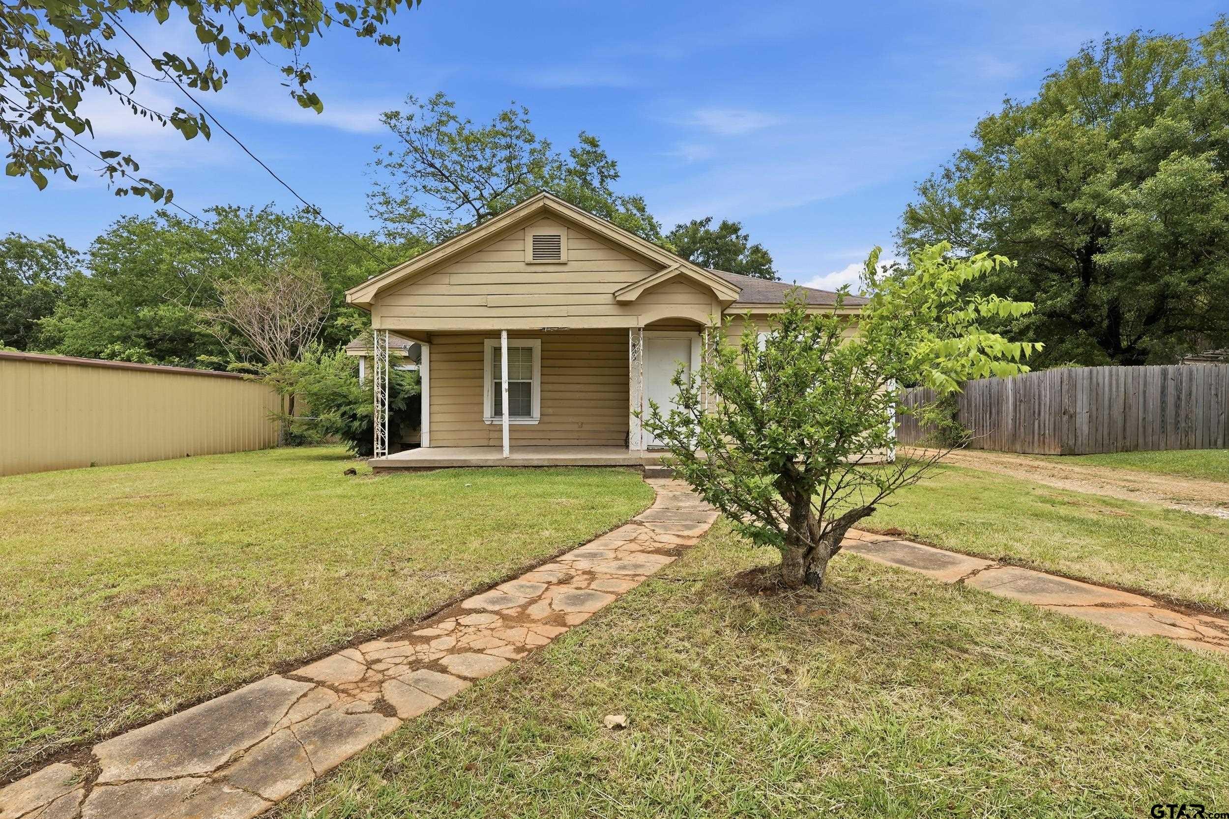 405 Rusk Street Pittsburg, TX 75686 - Photo 1 of 33 a view of a house with a yard