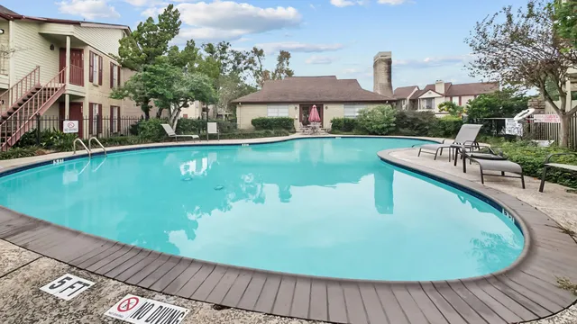 a view of a swimming pool with a patio