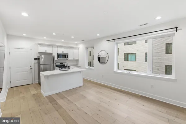 a view of kitchen with windows and refrigerator