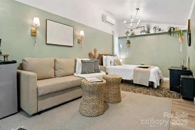 a living room with furniture and a chandelier