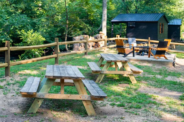 a backyard of a house with table and chairs