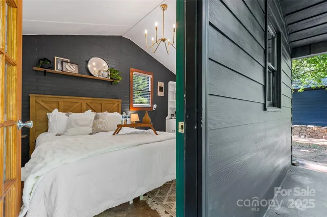 a bed room with a bed and a painting on the wall