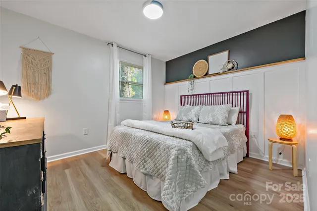 a bedroom with a bed and wooden floor