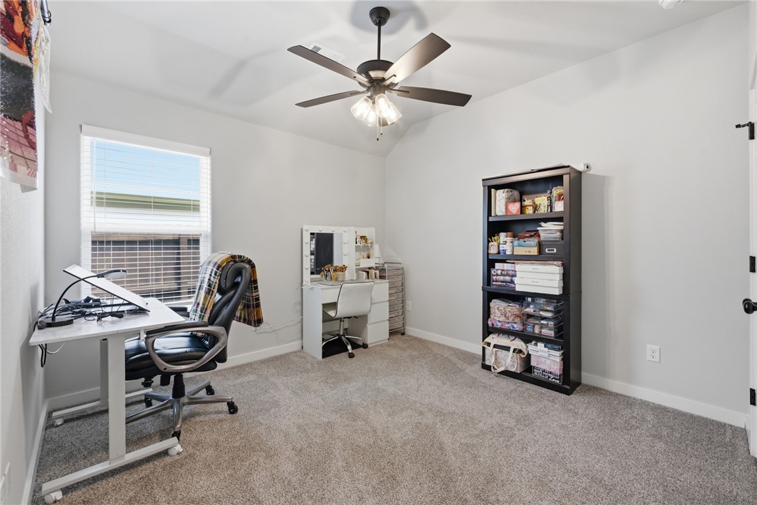 3112 Margaret Rudder Parkway Bryan, TX 77808 - Photo 19 of 24 a view of a workspace with furniture and a window