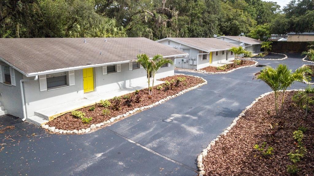 8012 Emi Ann Lane Riverview, FL 33578 - Photo 16 of 16 a view of a white house with a yard plants and large tree