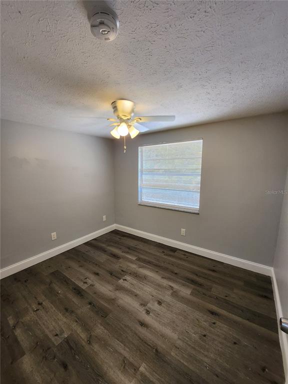 8012 Emi Ann Lane Riverview, FL 33578 - Photo 10 of 16 a view of an empty room with wooden floor and a window