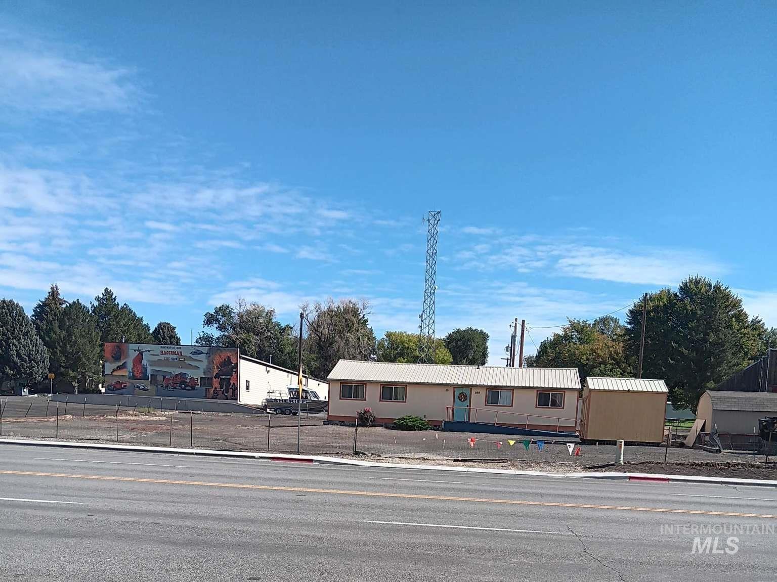 Manufactured / mobile home with a fenced front yard and a metal roof