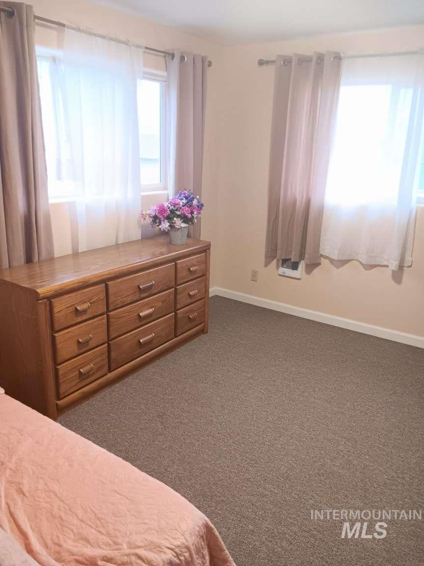 269 South State Street Hagerman, ID 83332 - Photo 17 of 29 Bedroom featuring baseboards and dark colored carpet