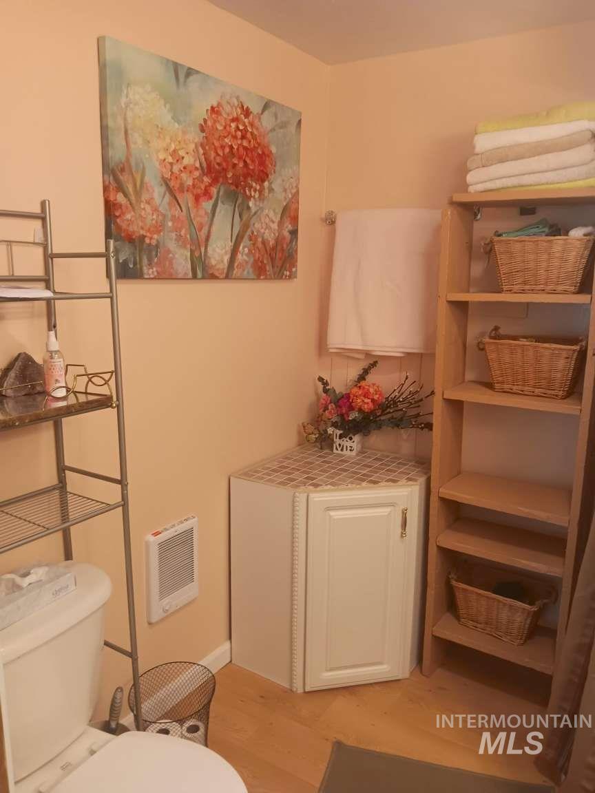 269 South State Street Hagerman, ID 83332 - Photo 18 of 29 Bathroom featuring heating unit and light wood finished floors