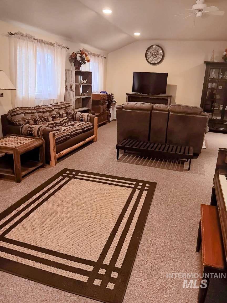 269 South State Street Hagerman, ID 83332 - Photo 21 of 29 Carpeted living area with vaulted ceiling, recessed lighting, and a ceiling fan