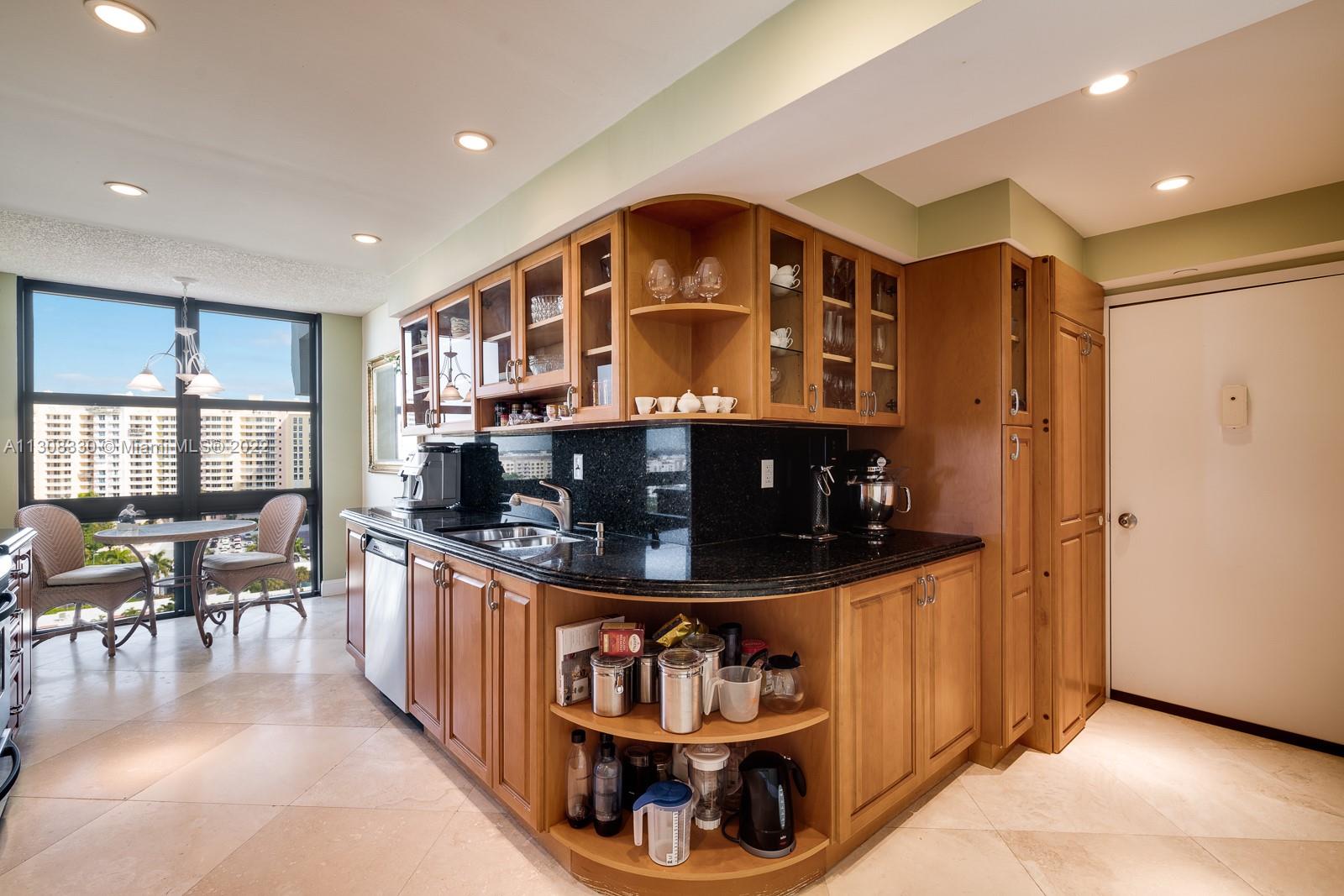 1121 Crandon Boulevard, Unit E1101 Key Biscayne, FL 33149 - Photo 12 of 31 a kitchen with stainless steel appliances granite countertop a stove and a refrigerator