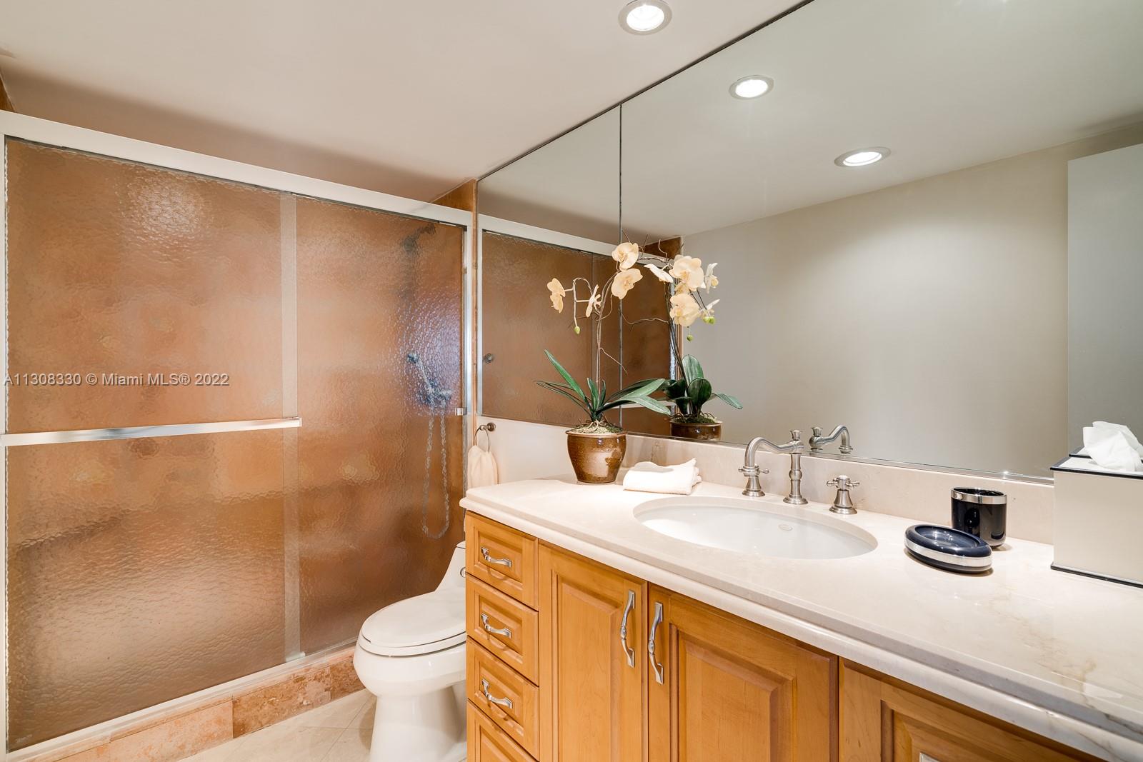 1121 Crandon Boulevard, Unit E1101 Key Biscayne, FL 33149 - Photo 17 of 31 a bathroom with a sink toilet and shower