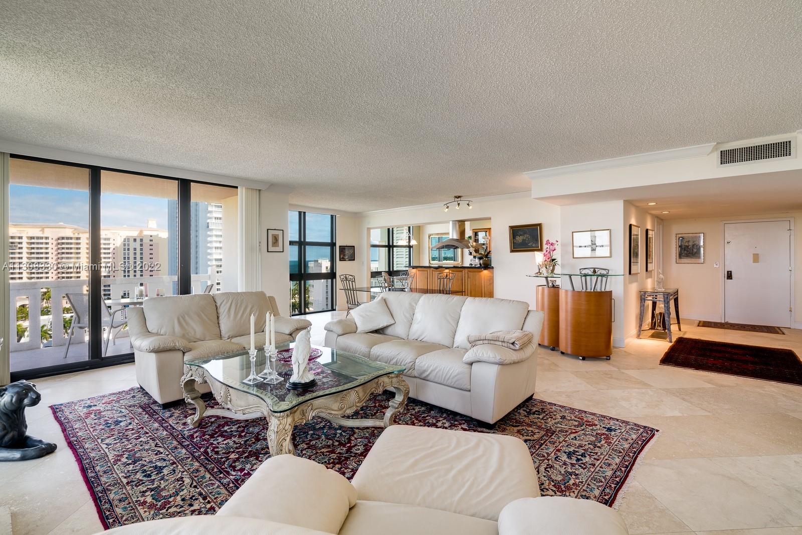 1121 Crandon Boulevard, Unit E1101 Key Biscayne, FL 33149 - Photo 8 of 31 a living room with furniture and a large window