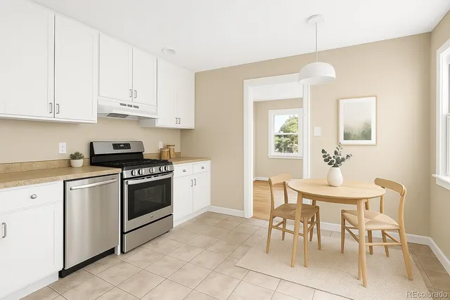 a kitchen with granite countertop white cabinets and stainless steel appliances