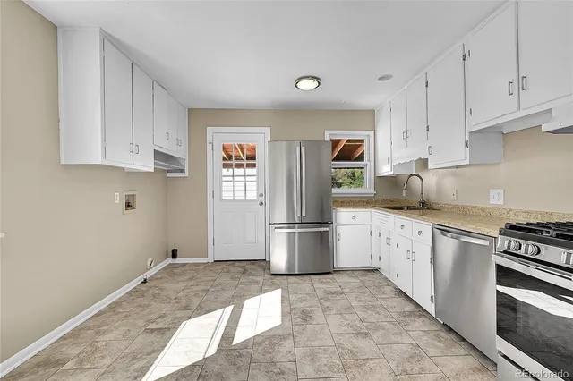 a kitchen with stainless steel appliances granite countertop a refrigerator sink and stove