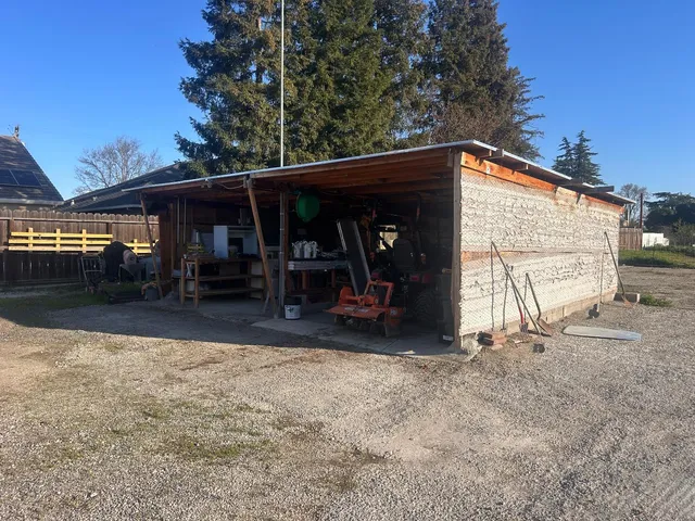 a view of a car park that has a small cabin