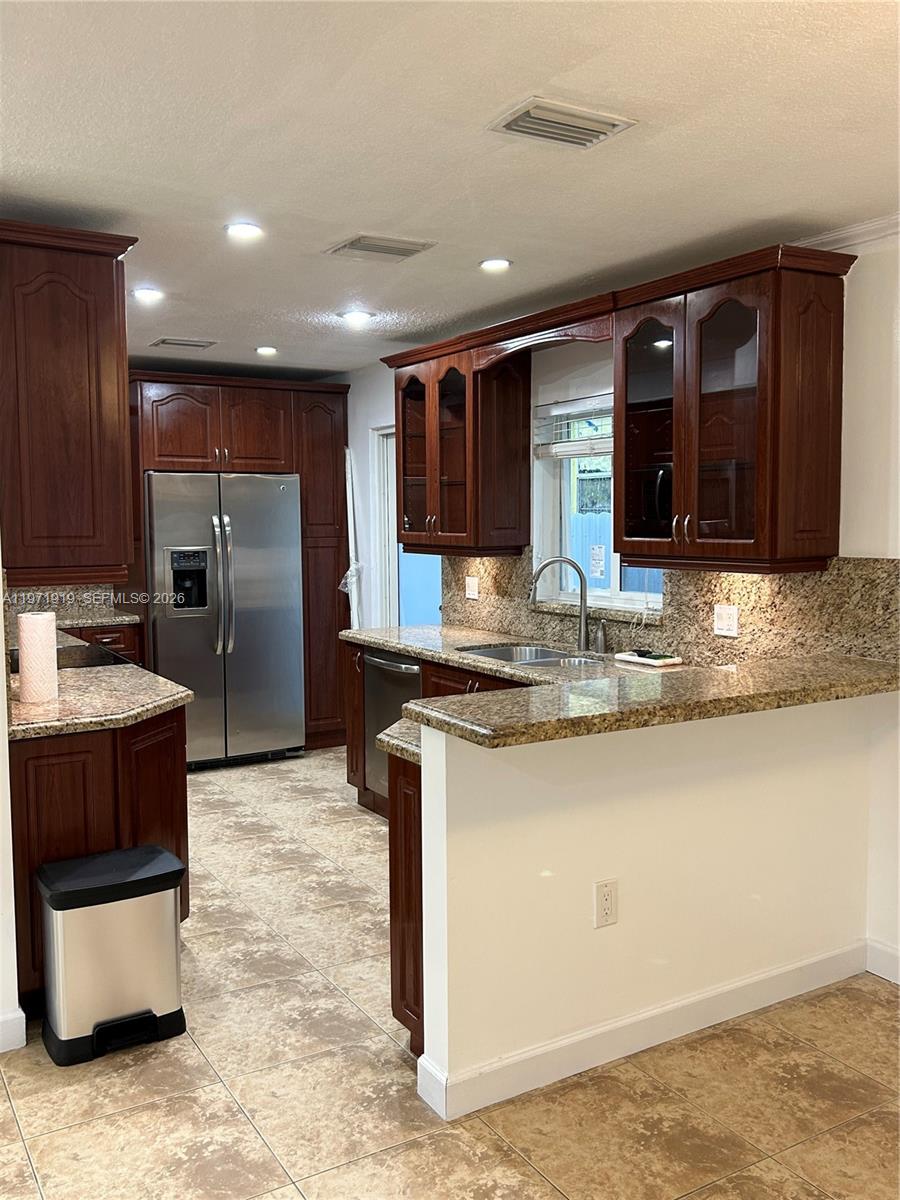 230 Southwest 30th Avenue, Unit 230 Miami, FL 33135 - Photo 1 of 22 a kitchen with stainless steel appliances granite countertop a sink and a refrigerator