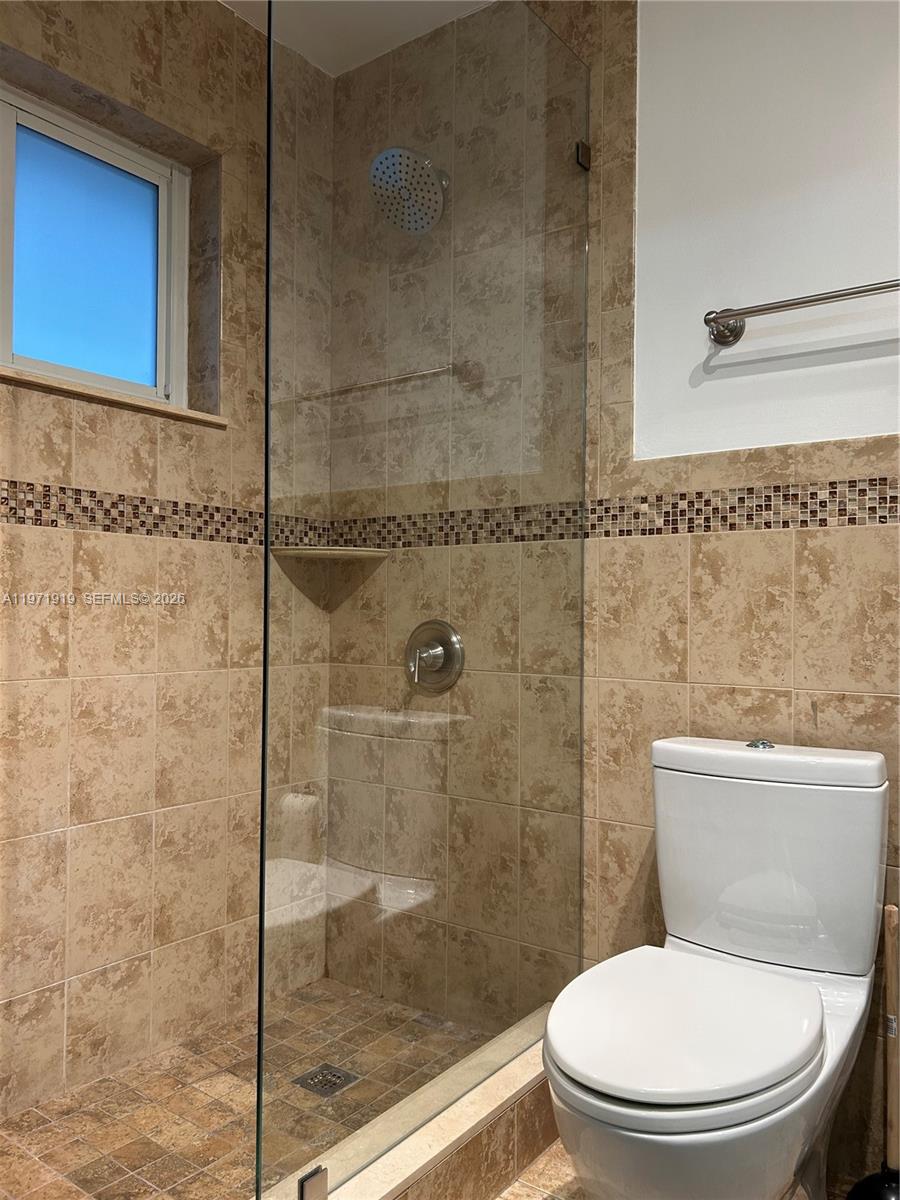 230 Southwest 30th Avenue, Unit 230 Miami, FL 33135 - Photo 11 of 22 a white toilet next to a bathroom