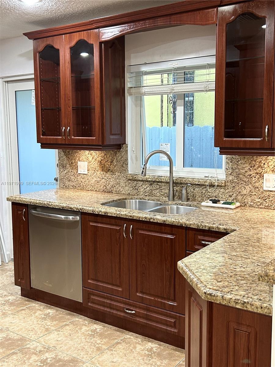 230 Southwest 30th Avenue, Unit 230 Miami, FL 33135 - Photo 2 of 22 a bathroom with a granite countertop sink and a mirror