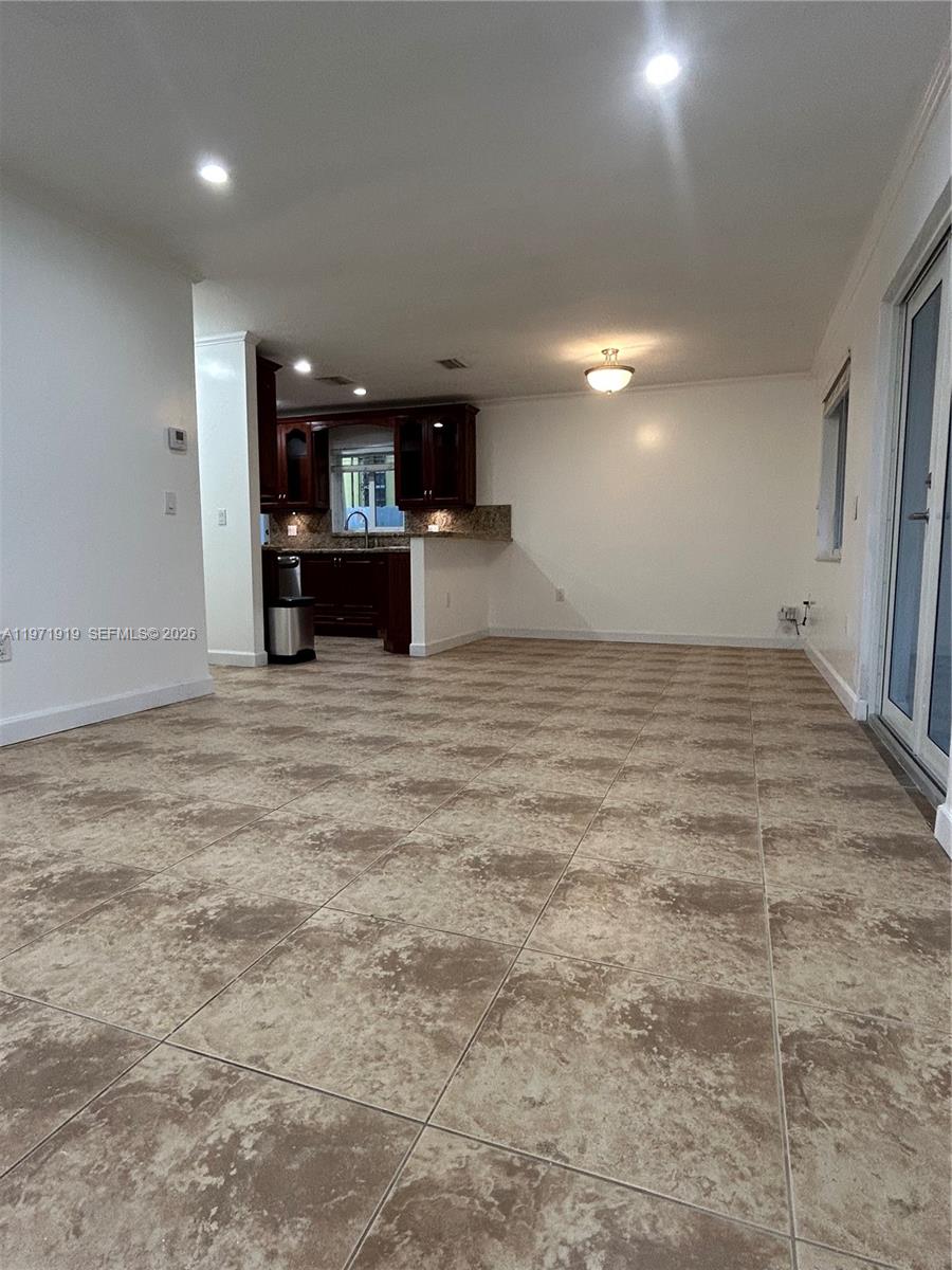 230 Southwest 30th Avenue, Unit 230 Miami, FL 33135 - Photo 5 of 22 a view of an empty room with kitchen and a window