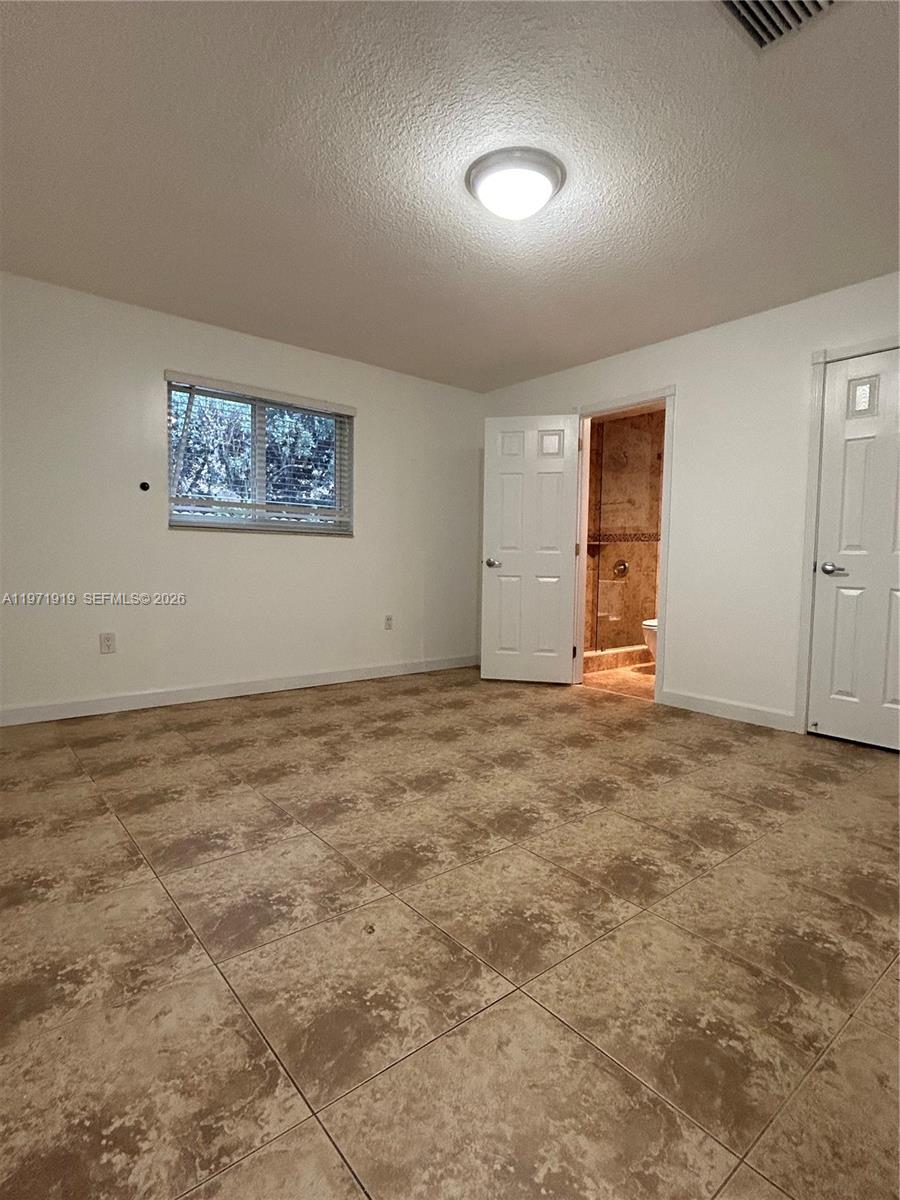 230 Southwest 30th Avenue, Unit 230 Miami, FL 33135 - Photo 7 of 22 an empty room with a natural light