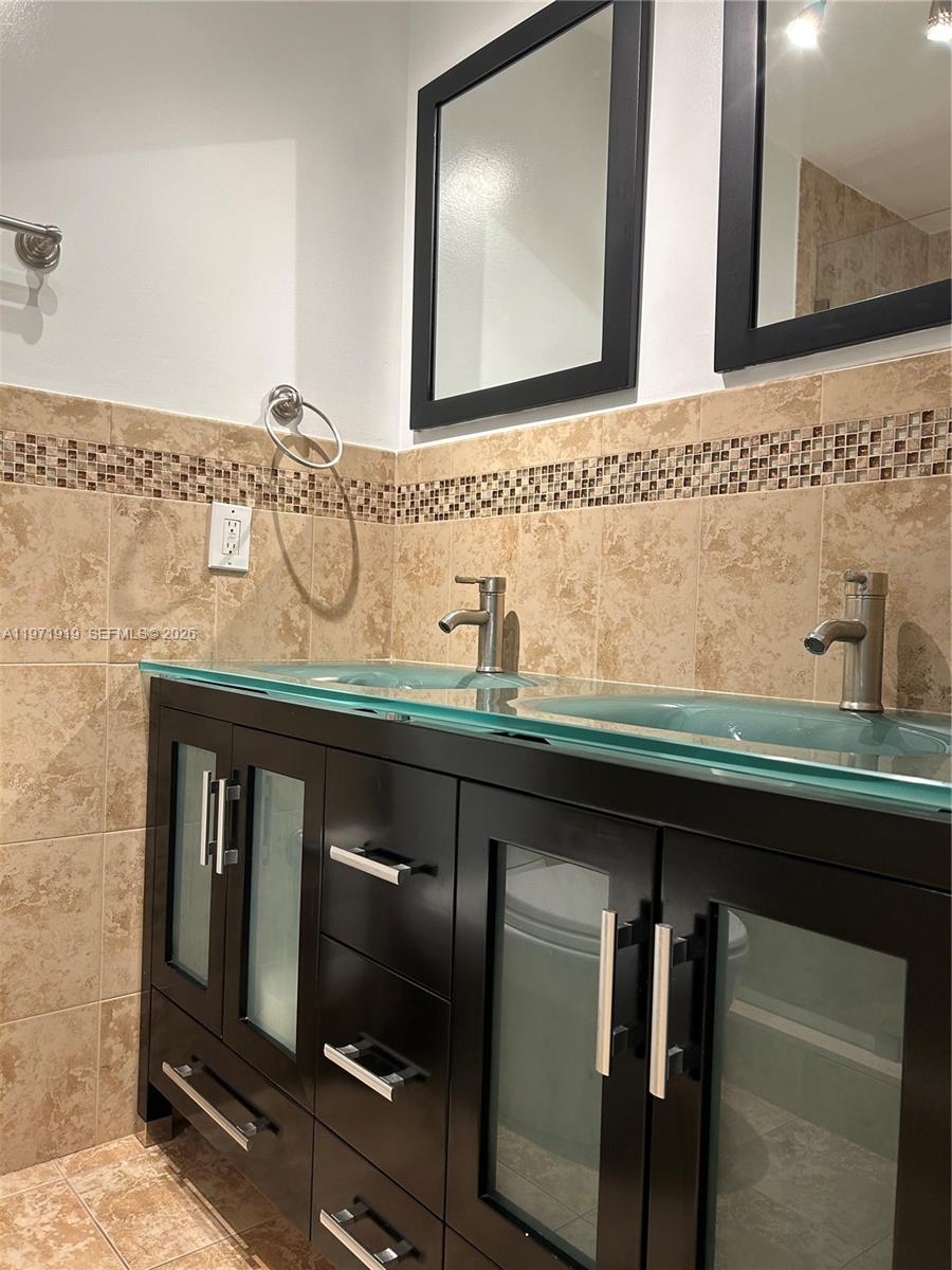 230 Southwest 30th Avenue, Unit 230 Miami, FL 33135 - Photo 9 of 22 a bathroom with a sink and a mirror