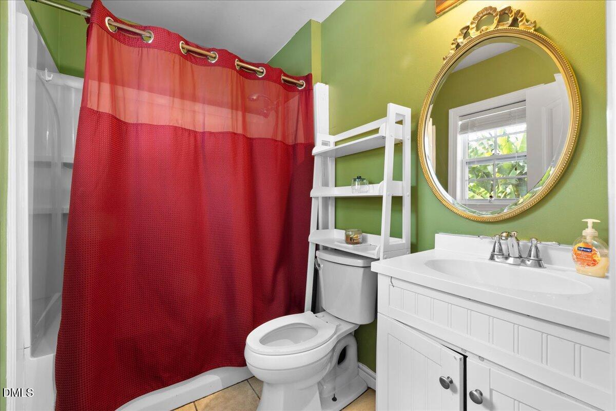 2323 Buckingham Road Burlington, NC 27217 - Photo 11 of 33 a bathroom with a sink a mirror and a toilet