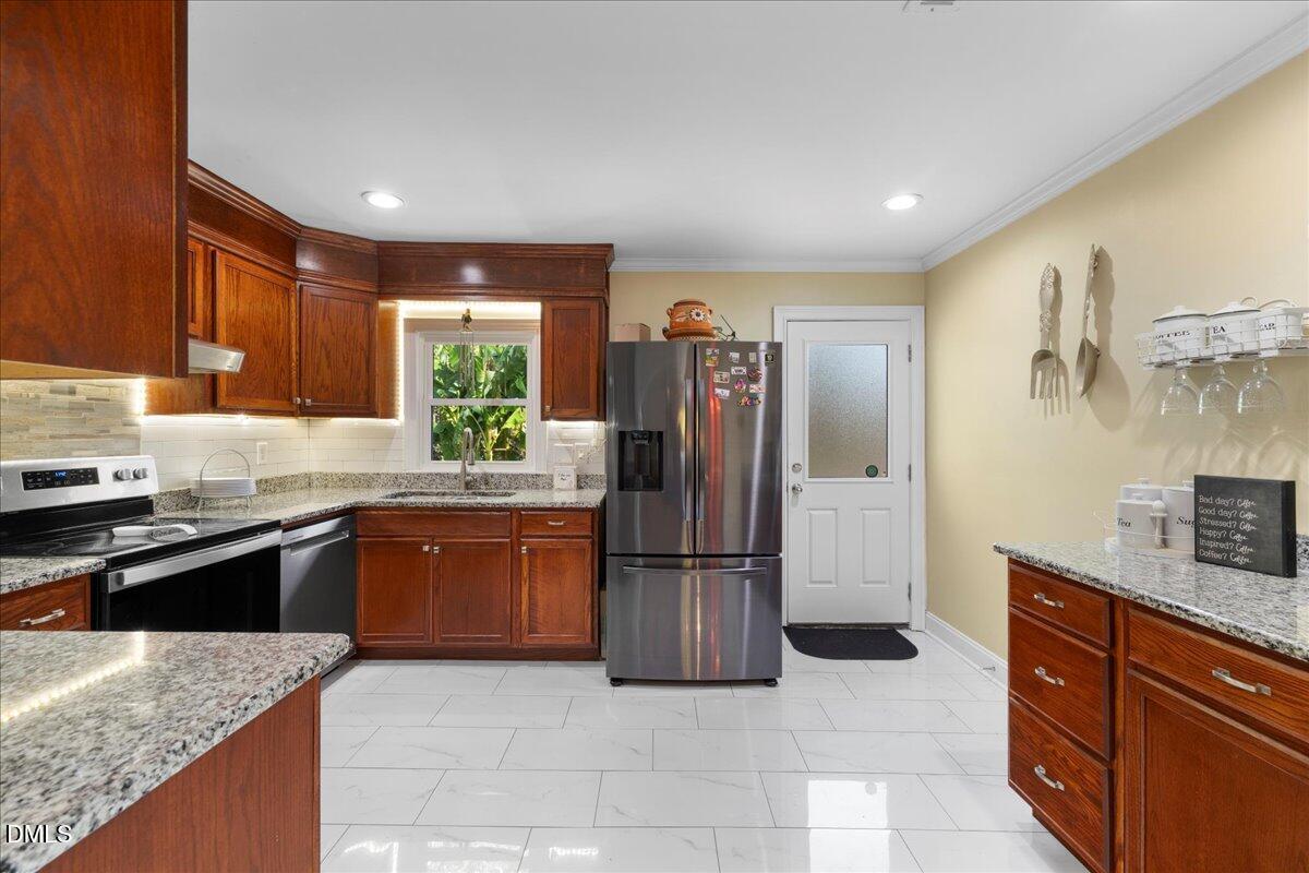 2323 Buckingham Road Burlington, NC 27217 - Photo 14 of 33 a kitchen with stainless steel appliances granite countertop a refrigerator and a sink
