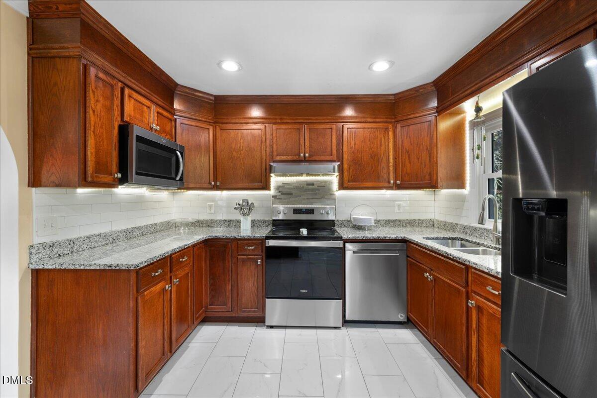 2323 Buckingham Road Burlington, NC 27217 - Photo 15 of 33 a kitchen with stainless steel appliances granite countertop a stove top oven microwave and refrigerator