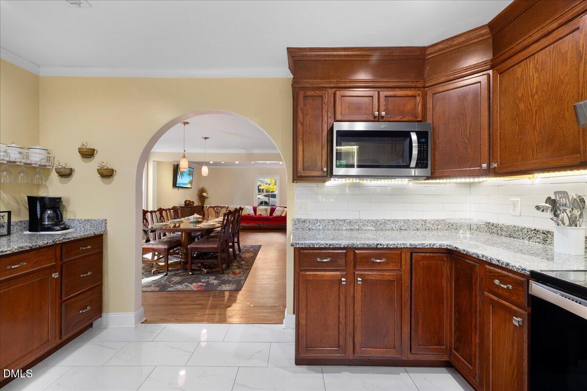 2323 Buckingham Road Burlington, NC 27217 - Photo 18 of 33 a kitchen with stainless steel appliances granite countertop a stove a sink and a microwave