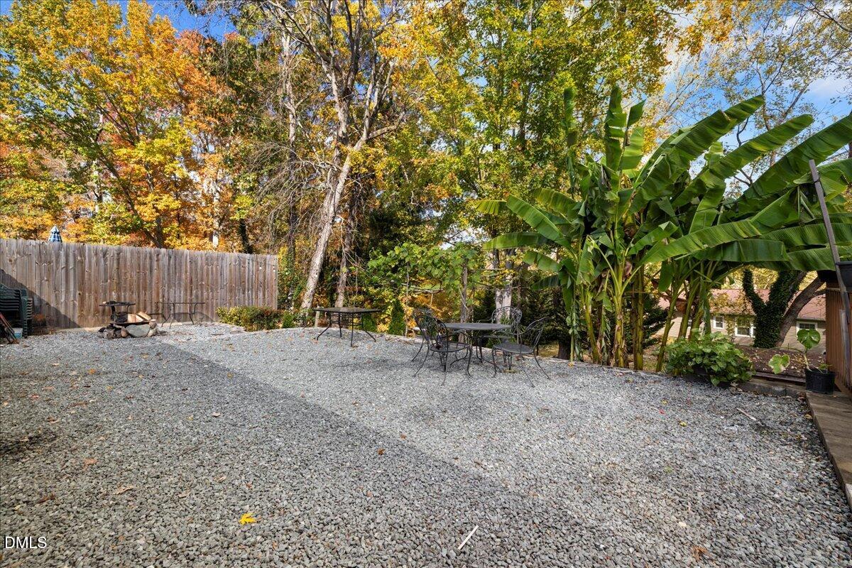 2323 Buckingham Road Burlington, NC 27217 - Photo 27 of 33 a view of backyard with table and chairs and a large tree
