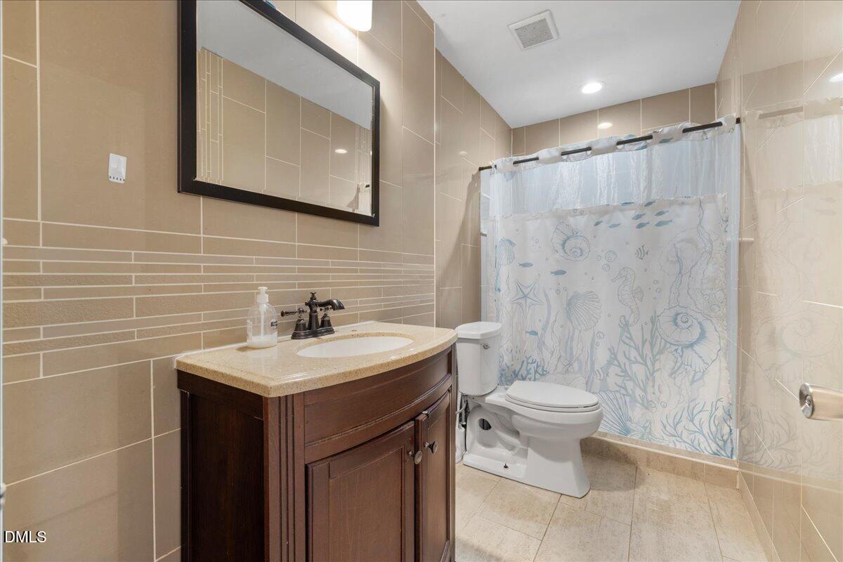 2323 Buckingham Road Burlington, NC 27217 - Photo 6 of 33 a bathroom with a sink toilet and shower