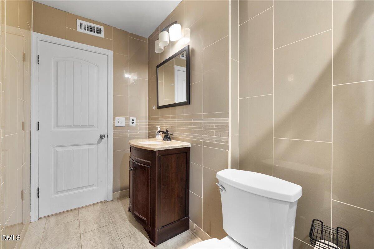 2323 Buckingham Road Burlington, NC 27217 - Photo 7 of 33 a bathroom with a toilet sink and mirror