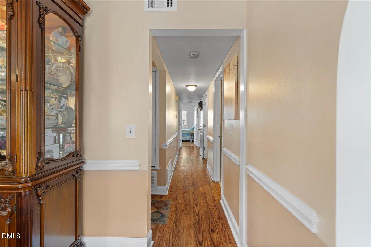 2323 Buckingham Road Burlington, NC 27217 - Photo 8 of 33 a view of a hallway with wooden floor and staircase