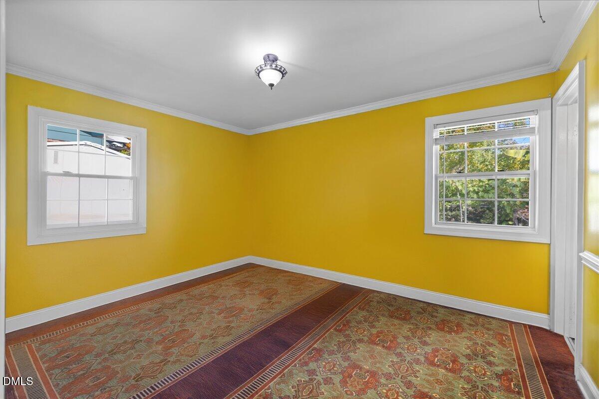 2323 Buckingham Road Burlington, NC 27217 - Photo 10 of 33 a view of an empty room with a window and wooden floor