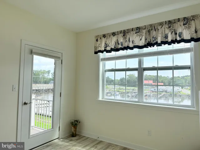 a view of wooden floor and a window in a room